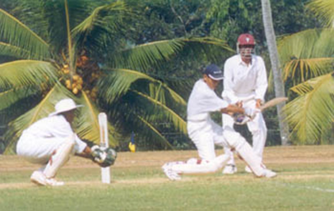 Subhojit Paul hits the ball square of the wicket as wicketkeeper Vinoth and forward short-leg Vijay Sarathy look on, Vijay Merchant Trophy 1999/2000, 1st Pre Quarter Final, Bengal Under-16s v Tamil adu Under-16s at Vellyani Agricultural College Ground, Thiruvananthapuram, 01-03 Jan 2000
