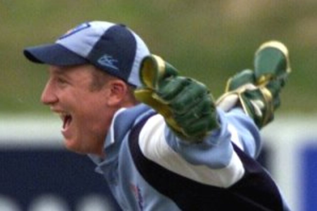 16 Jan 2000: Duncan Brede of Canberra Comets is the last wicket to fall as NSW Blues wicketkeeper Brad Haddin celebrates during the NSW Blues v Canberra Comets Mercantile Mutual Cup game at Manuka Oval, Canberra, Australia.