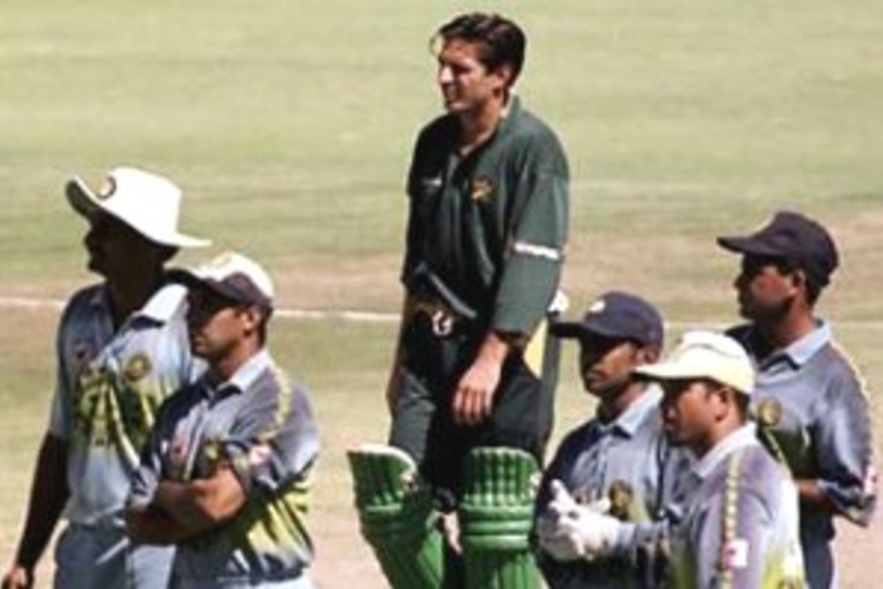 28 Jan 2000: Shahid Afridi of Pakistan waits for the third umpires decision surrounded by Indian fielders as his partner Ijaz Ahmed is run out for 13 during the Carlton and United Breweries one day international between India and Pakistan at the WACA Ground, Perth, Australia.