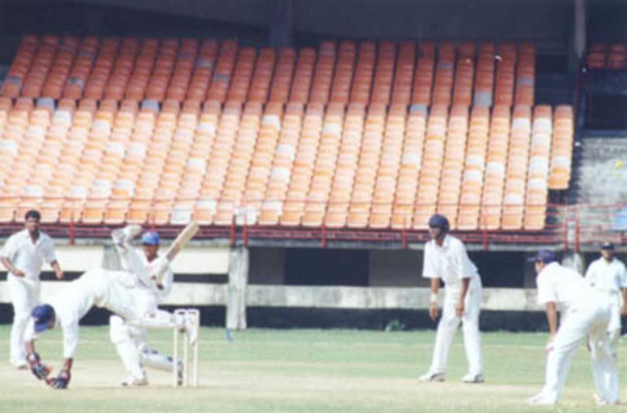 Ajay Kudua pulls Balaji Rao as keeper tries to stop the ball. Ranji Trophy South Zone League, 2000/01, Kerala v Tamil Nadu, Nehru Stadium, Kochi, 29Nov-02Dec 2000.