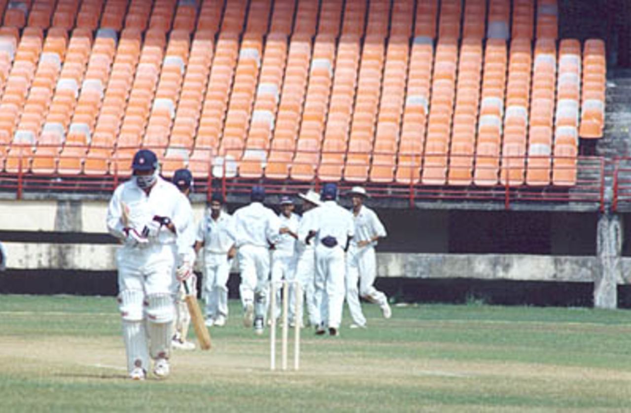 Robin Singh walks back after being caught by Suresh Kumar at mid on off Sreekumar Nair. Ranji Trophy South Zone League, 2000/01, Kerala v Tamil Nadu, Nehru Stadium, Kochi, 29Nov-02Dec 2000.