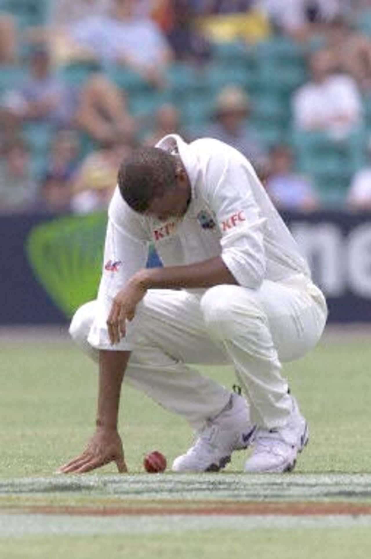 West Indian fast bowler Courtney Walsh is dejected as he struggles with an ankle injury in the Federation test at the Sydney Cricket ground 04 January 2001. Australia is currently 5-352 with the West Indies making 272 in the first innings.