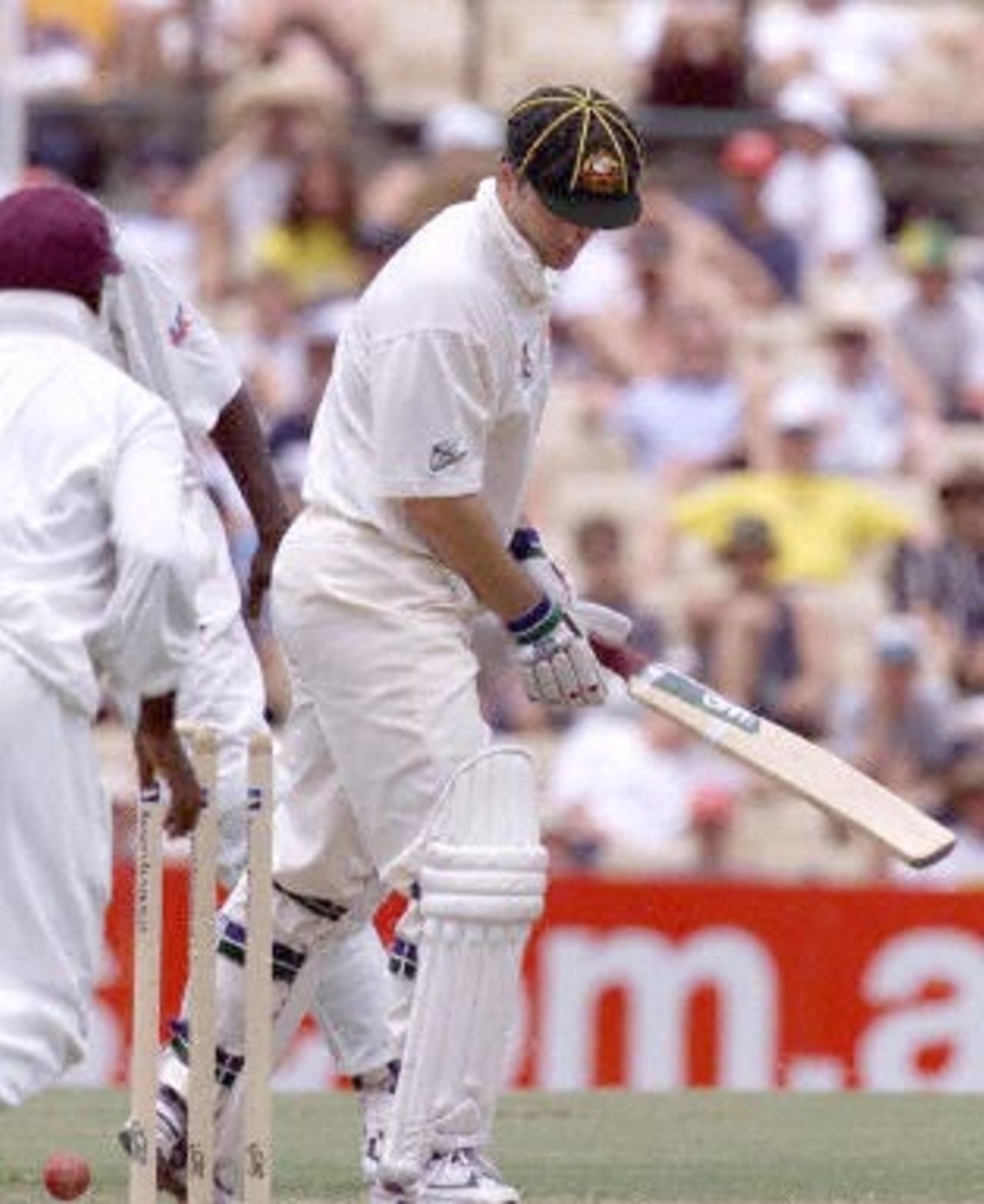 Australian captain Steve Waugh looks down and realises he has caused his own dismissal after he kicked the ball onto the wicket off the bowling of Mahendra Nagamootoo in the Federation test at the Sydney Cricket ground 04 January 2001. Waugh made 103 and Australia is 6-373 with the West Indies making 272 in the first innings.