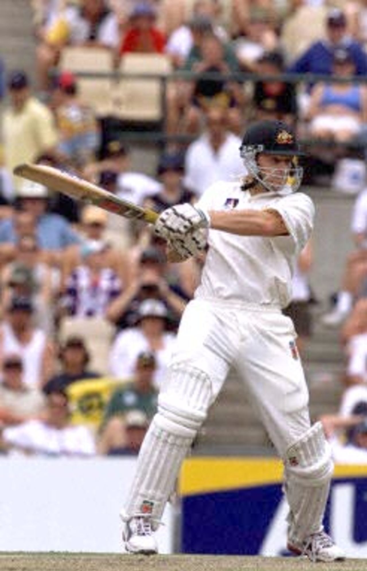 Australian left-handed batsman Adam Gilchrist slogs a four off the bowling off Courtney Walsh in the Federation test at the Sydney Cricket ground 04 January 2001. Australia is currently 5-356 with the West Indies making 272 in the first innings.
