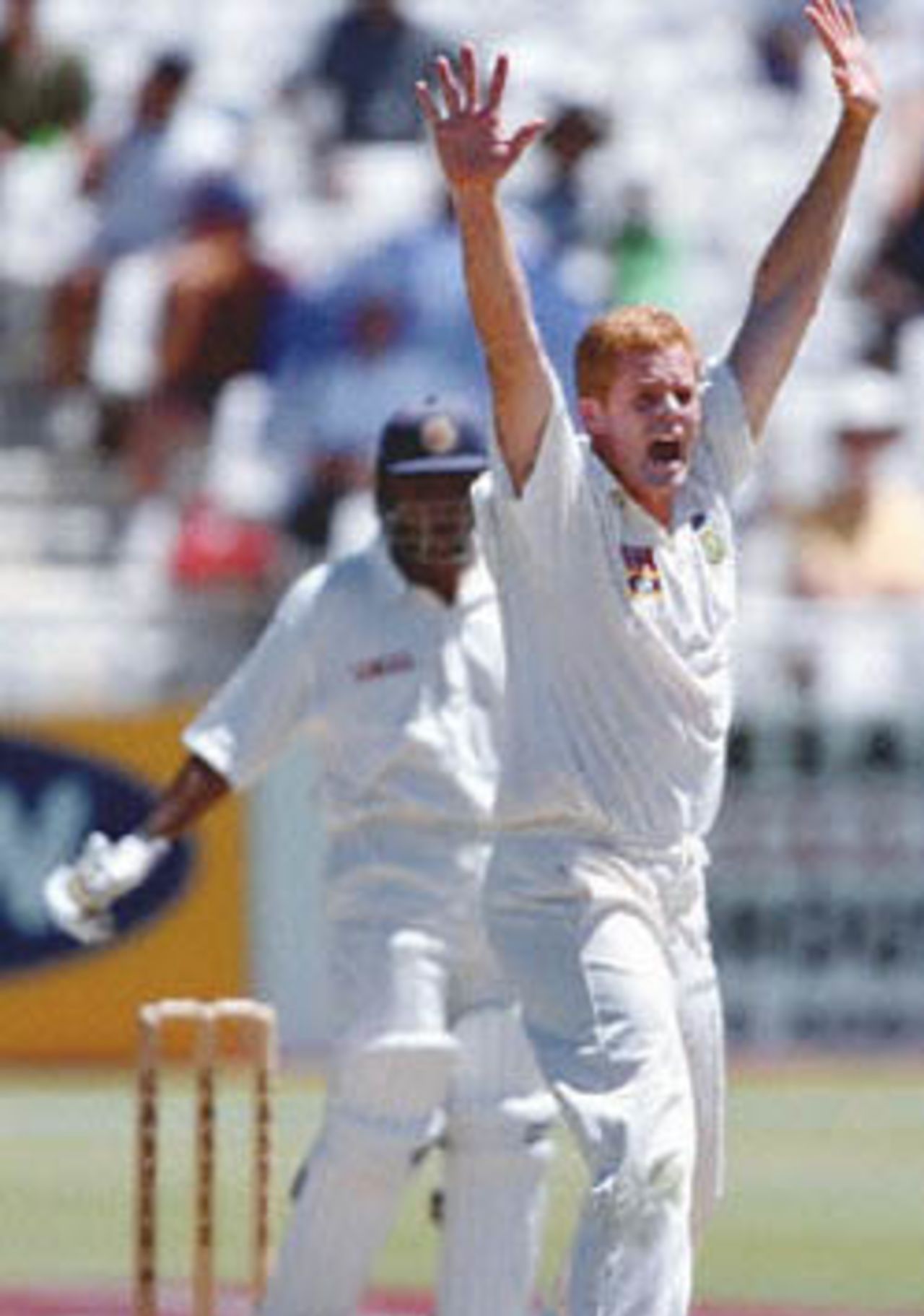 South Africa's fast bowler and captain Shaun Pollock (R) appeals for a wicket against Mahela Jayawardene 04 January 2001 on the third day of the second test between South Africa and Sri Lanka played at the Newlands cricket ground in Cape Town.