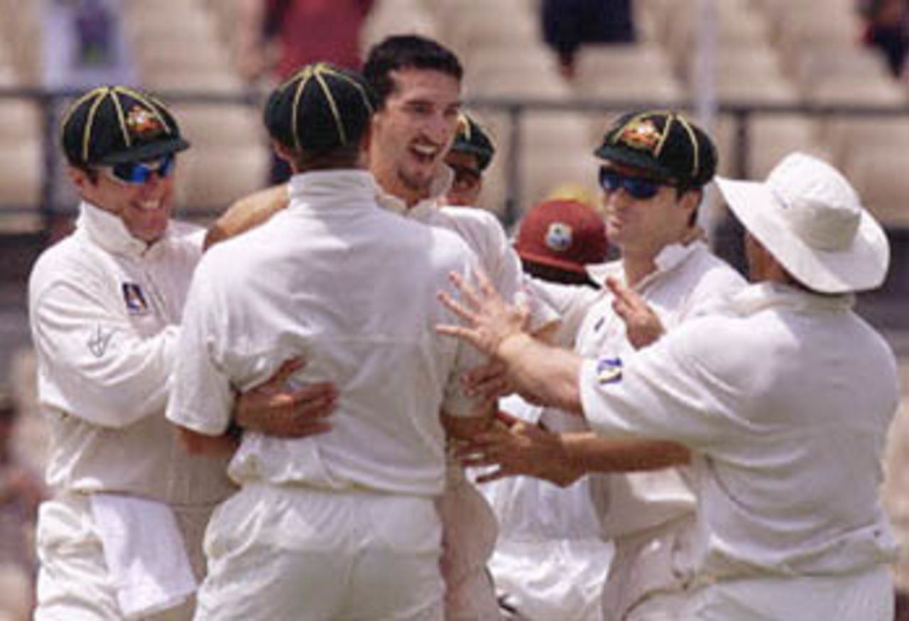 Australian fast-bowler Jason Gillespie (C) is congratulated by team-mates after taking the wicket of Sherwin Campbell in the Federation test at the Sydney Cricket ground 05 January 2001. Campbell made 54 before being caught by Australian wicket-keeper Adam Gilchrist off the bowling of Jason Gillespie.
