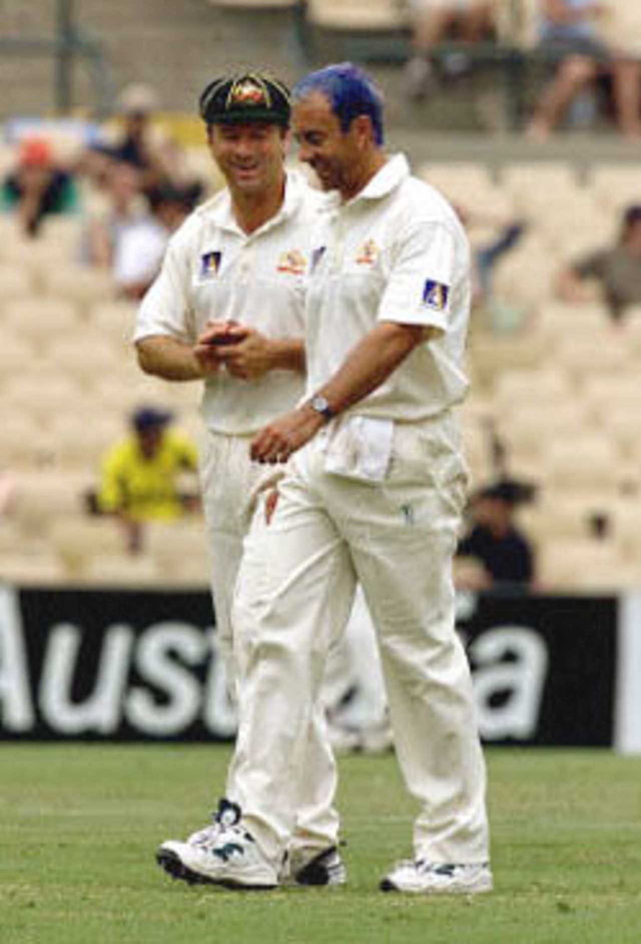 Australian captain Steve Waugh (L) chats with bowler Colin Miller (R) after he dropped a catch in the out-field from Brian Lara in the Federation test at the Sydney Cricket ground 05 January 2001. Miller took the wicket of Lara a few minutes later. Lara made 20 runs and the West Indies is currently 5- 190 in the second innings having forced the Australians into a second innnings.