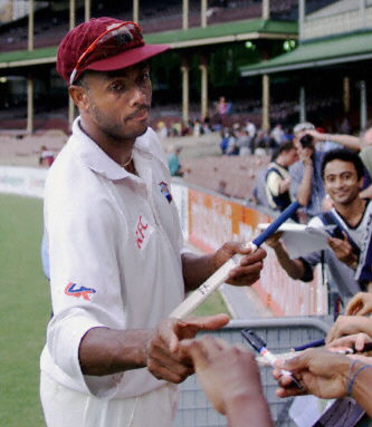 West Indian fast bowler Courtney Walsh signs autographs after the end of play on day four of the Federation test at the Sydney Cricket ground 05 January 2001. Walsh had just completed his last batting spell at the SCG and capped the day off by taking the wicket of top-order Australian batsman Justin Langer.