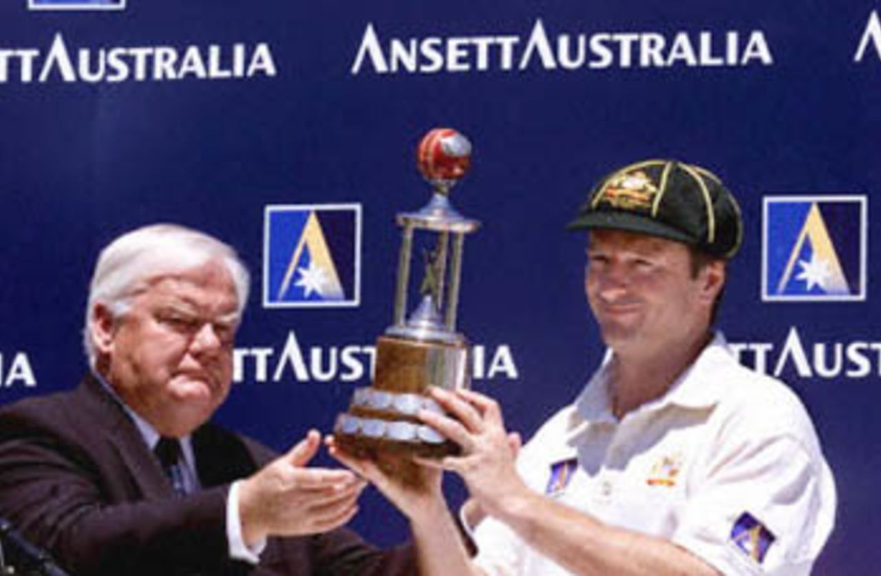 Australian captain Steve Waugh receives the Sir Frank Worrell Trophy from Australian cricket board chairman Denis Rogers after Australia won the Federation test at the Sydney Cricket ground 06 January 2001. Australia won the five day test against the West Indies with 7 wickets in hand.