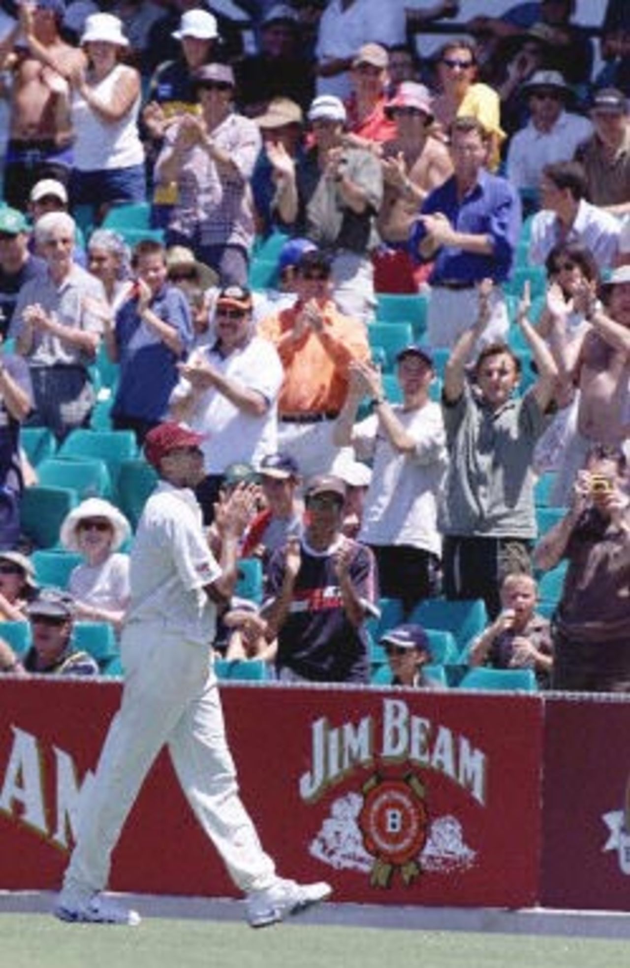 Legendary West Indian fast bowler Courtney Walsh receives a standing ovation from the crowd and returns the compliment near the end of play in the Federation Test at the Sydney Cricket Ground, 06 January 2001. The West Indies' 38-year-old world record wicket-taker was feted for playing his final Test in Australia. Victory came easy for Australia with a six-wicket victory over the West Indies in the fifth cricket Test to clinch a 5-0 series clean sweep and their 15th consecutive Test win.
