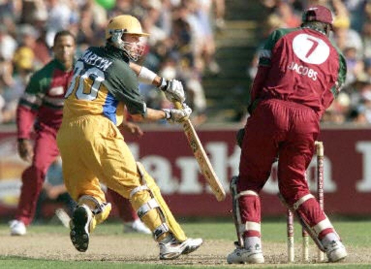 Australian batsman Damien Martyn (C) dabs a ball away point as West Indian wicketkeeper Ridley Jacobs (R) and bowler Marlon Samuels (L) look on in their one day clash at the MCG in Melbourne, 11 January 2000. Australia scored 267-6 off their 50 overs with the West Indies about to start their innings.