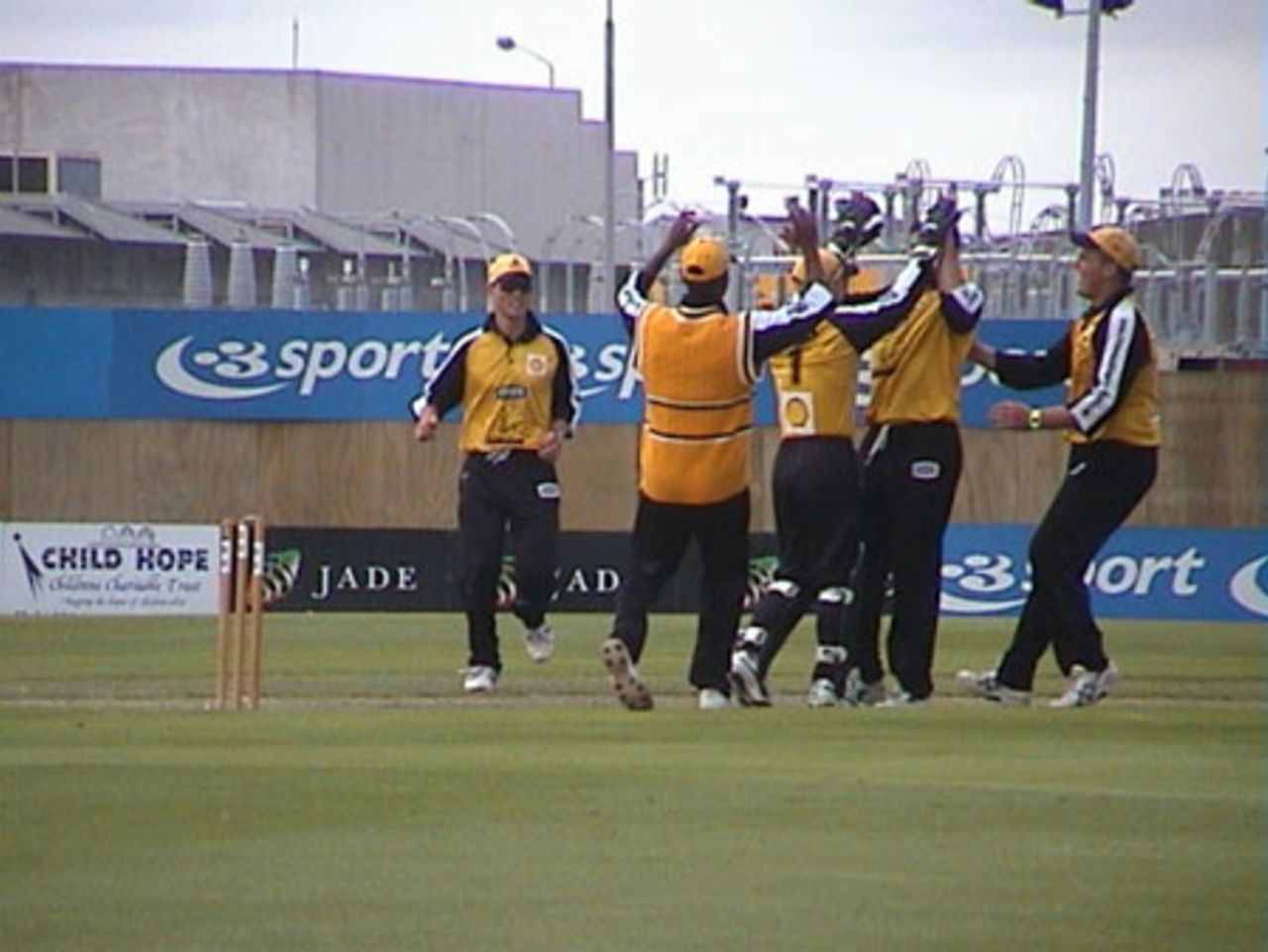 Wellington players gather to celebrate the taking of a Canterbury wicket, Shell Cup: Canterbury v Wellington at Jade Stadium, Christchurch, 18 January 2001