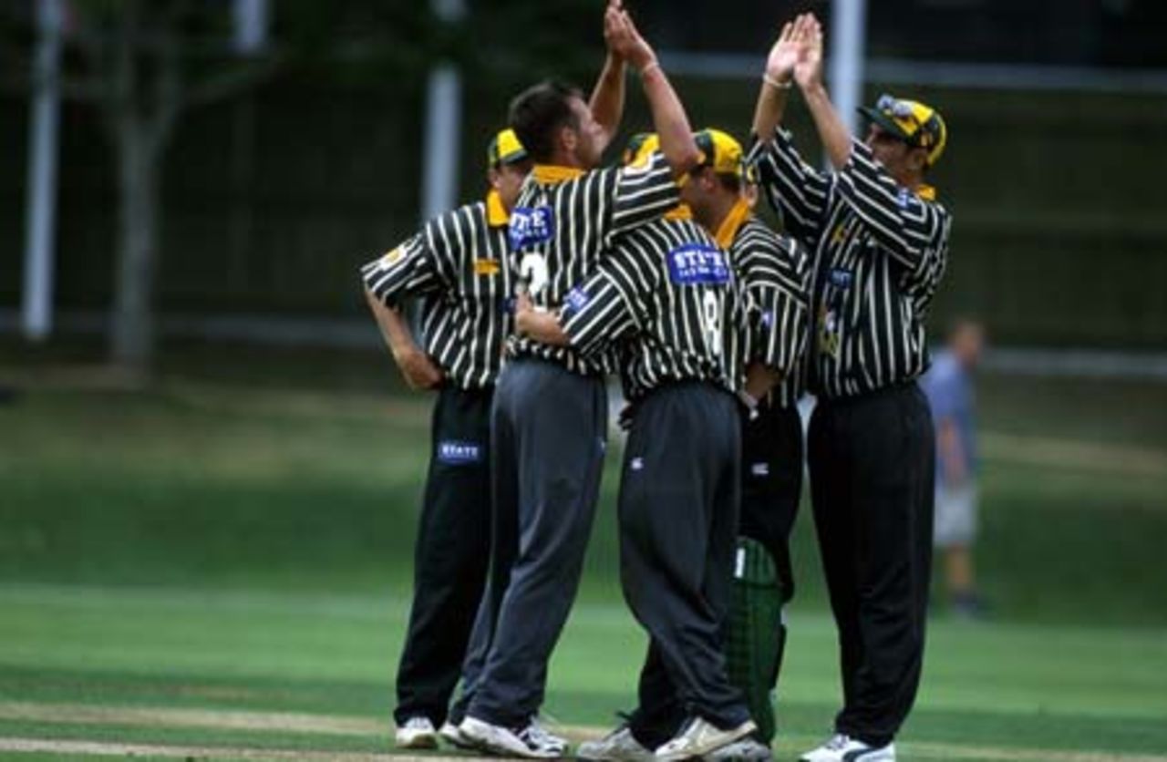 Central Districts fielder Mathew Sinclair high-fives the successful bowler upon the fall of an Auckland wicket in their dismal total of 73, Shell Cup: Auckland v Central Districts at Eden Park Outer Oval, Auckland, 16 January 2001