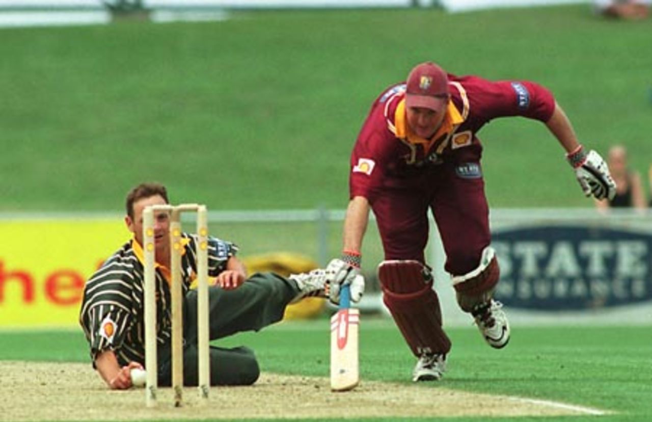 Northern Districts batsman Grant Bradburn is forced to dive back into his crease after being sent back by his batting partner as Central Districts bowler Andrew Schwass fields off his own bowling. Schwass elected not to throw at the stumps. Shell Cup Semi Final: Central Districts v Northern Districts at McLean Park, Napier, 21 January 2001