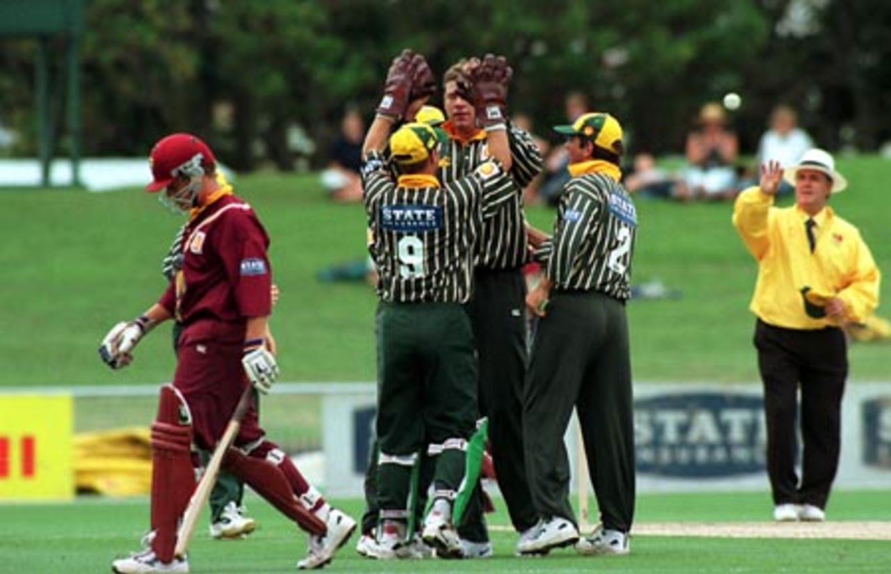 Successful Central Districts bowler Jacob Oram high-fives wicket-keeper Bevan Griggs upon the dismissal of James Marshall for 12, caught by David Kelly (standing to Oram's left). Umpire Doug Cowie receives the ball in the background. Shell Cup Semi Final: Central Districts v Northern Districts at McLean Park, Napier, 21 January 2001.
