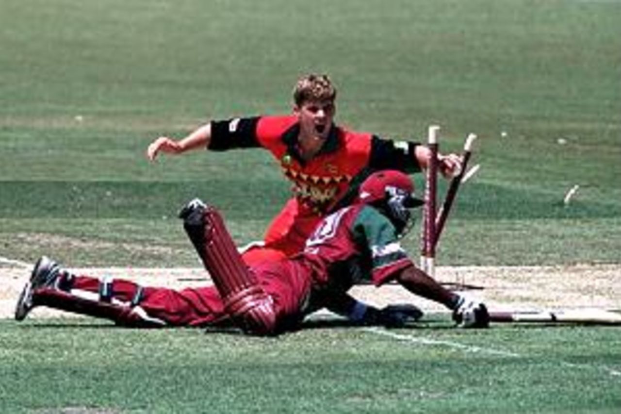 25 Jan 2001: Bryan Strang of Zimbabwe runs out Daren Ganga of the West Indies for six during the Carlton Series One Day International between West Indies and Zimbabwe at the Adelaide Oval in Adelaide, Australia.