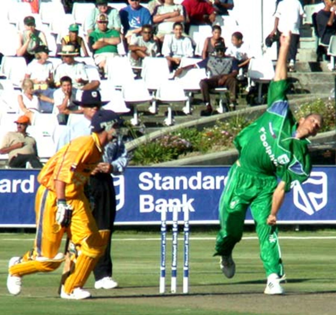 John Kent sends down a delivery why Stephen Cook backs-up at the non-strikers end