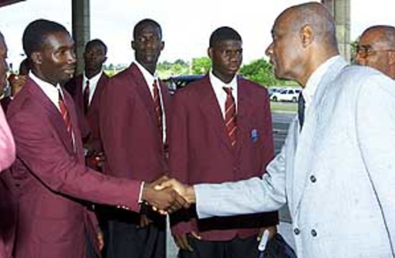 Alcindo Holder, a member of the Young West Indies cricket team, greets Rev. Wes Hall, president of the West Indies Cricket Board, before departing for the Youth World Cup on Thursday.