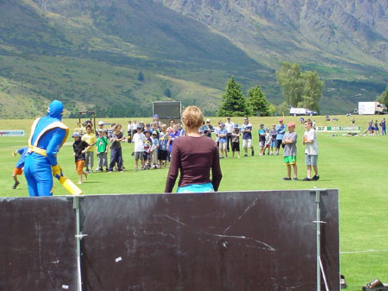 Voltman, Otago Cricket's live mascot, lines up to face the bowling of some kids during a lunchtime promotion at the first match to be played at the new ground. State Shield: Otago v Wellington at John Davies Oval, Queenstown, 2 January 2002.
