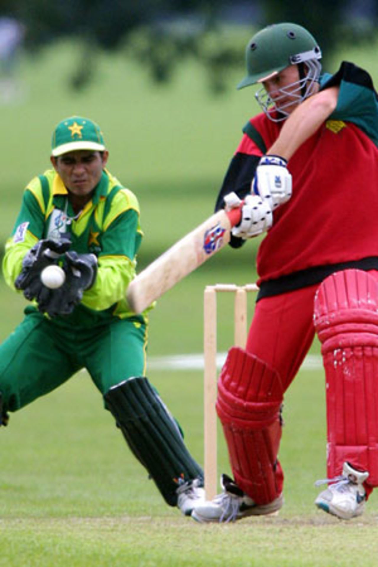 Zimbabwe Under-19 batsman Charles Coventry cuts at a delivery as Pakistan Under-19 wicket-keeper Amin-ur-Rehman shapes to take it. ICC Under-19 World Cup Warmup: Pakistan Under-19 v Zimbabwe Under-19 at Hagley Oval, Christchurch, 16 January 2002.