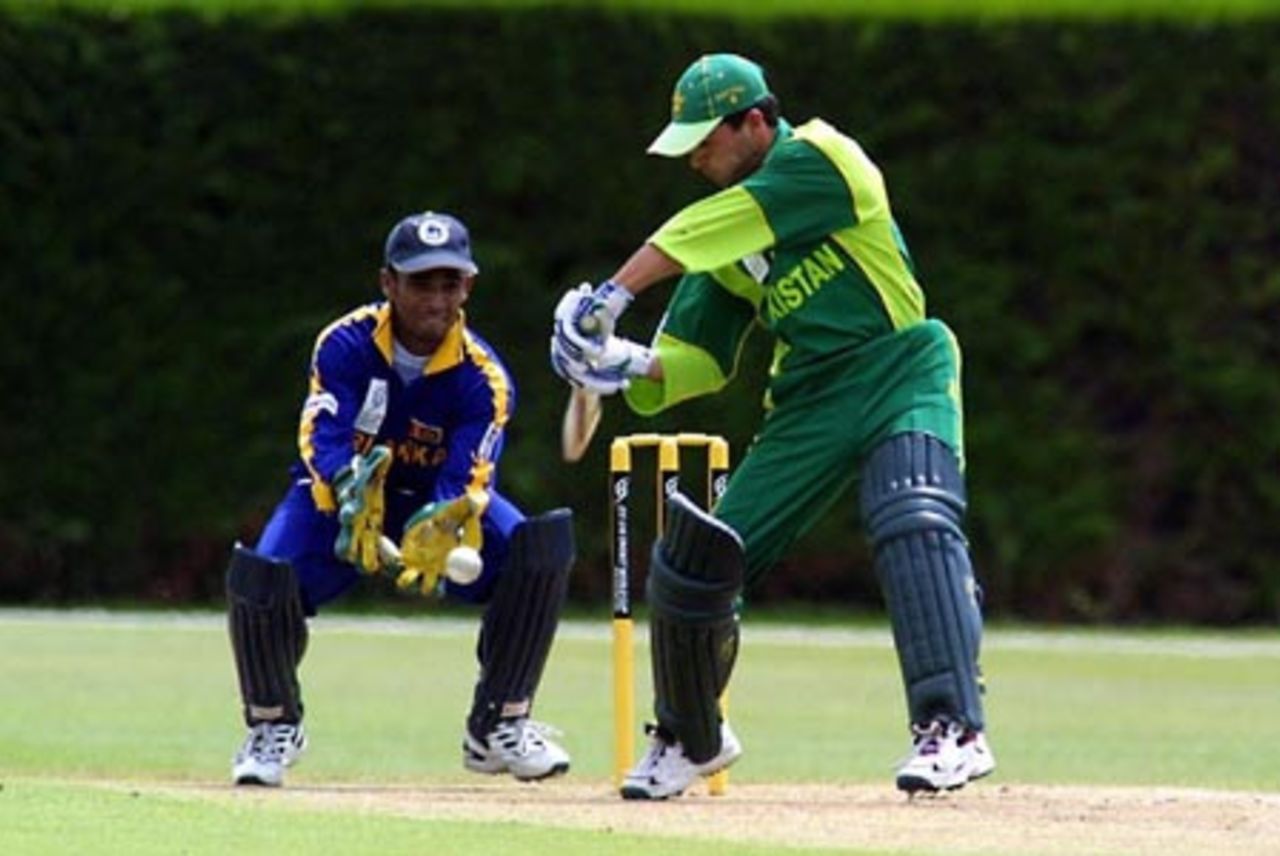 Pakistan Under-19 batsman Mohammad Fayyaz shapes to cut a delivery during his innings of 53. Sri Lanka Under-19 wicket-keeper Charith Sylvester looks on. ICC Under-19 World Cup Super League Group 1: Pakistan Under-19s v Sri Lanka Under-19s at Lincoln No. 3, Lincoln, 27 January 2002.