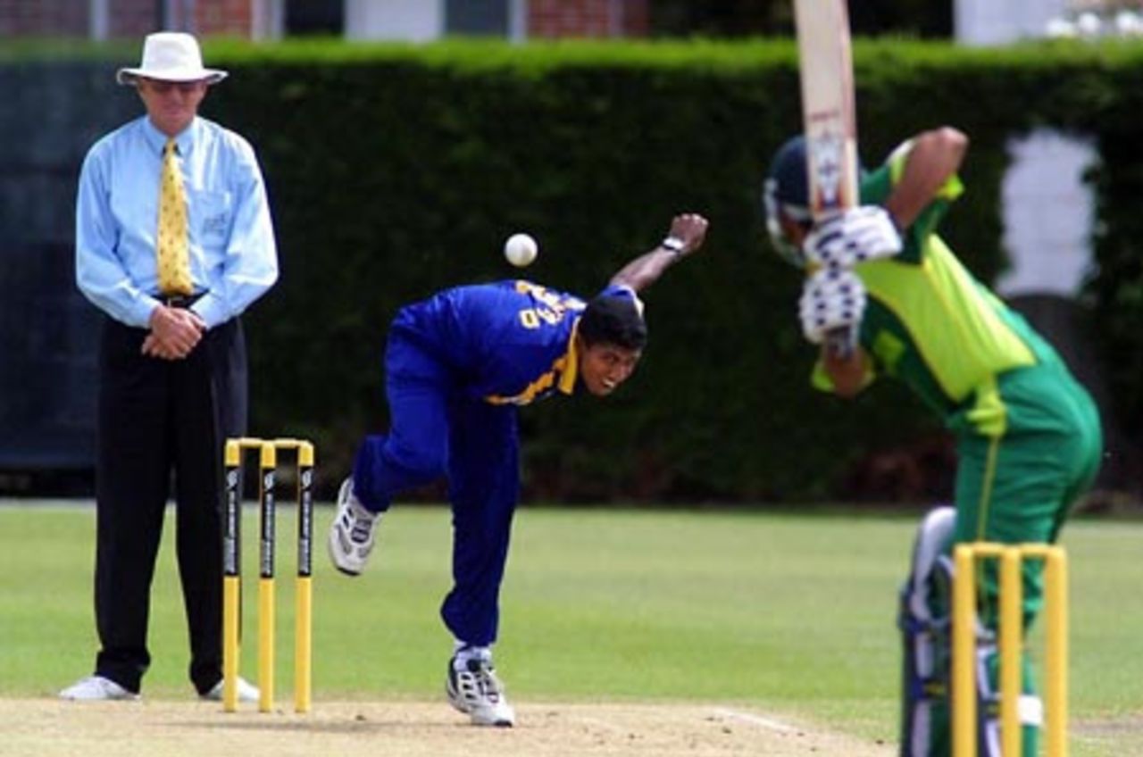 Sri Lanka Under-19 bowler Dammika Prasad delivers a ball to Pakistan Under-19 batsman Kamran Sajid during his spell of 4-30 from 8.3 overs. Umpire Tony Cooper from Fiji looks on. ICC Under-19 World Cup Super League Group 1: Pakistan Under-19s v Sri Lanka Under-19s at Lincoln No. 3, Lincoln, 27 January 2002.