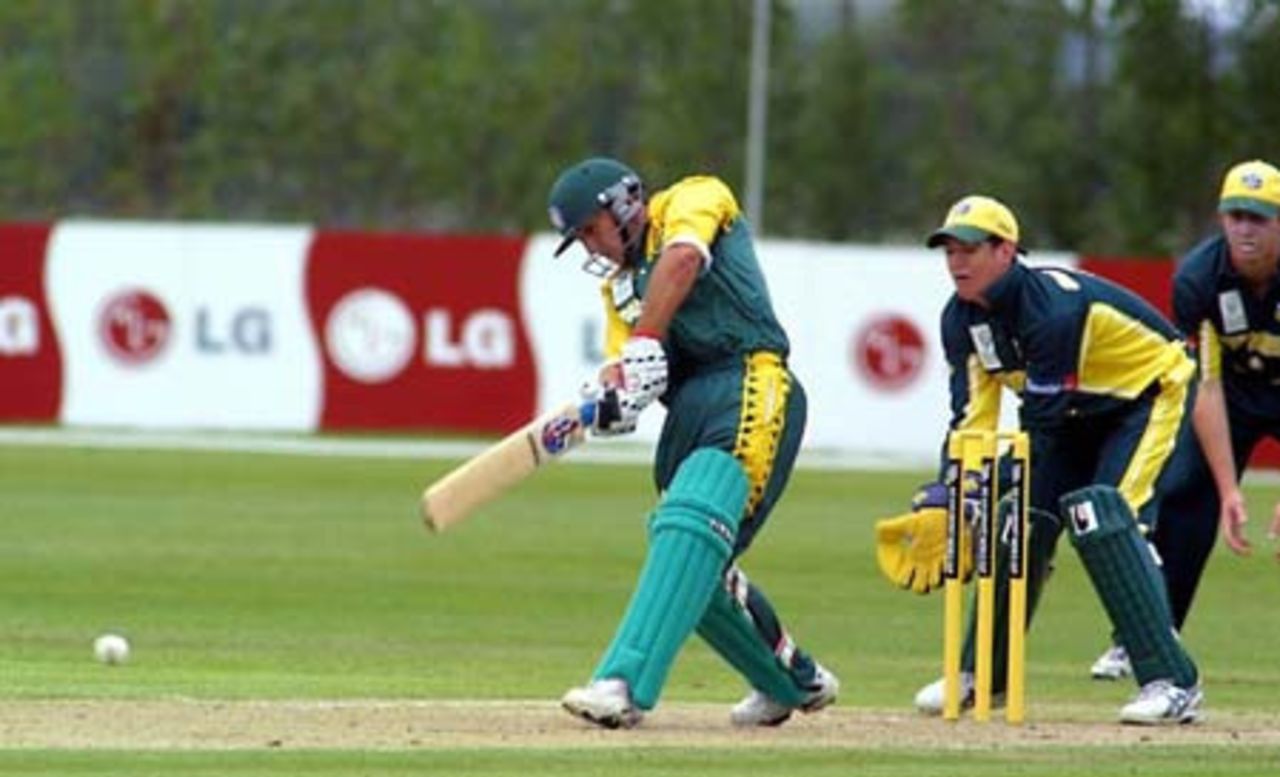 South Africa Under-19 batsman Riel de Kock drives a delivery straight back down the pitch during his innings of 37. Australia Under-19 wicket-keeper Adam Crosthwaite looks on. ICC Under-19 World Cup Super League Group 2: Australia Under-19s v South Africa Under-19s at Bert Sutcliffe Oval, Lincoln, 28 January 2002.