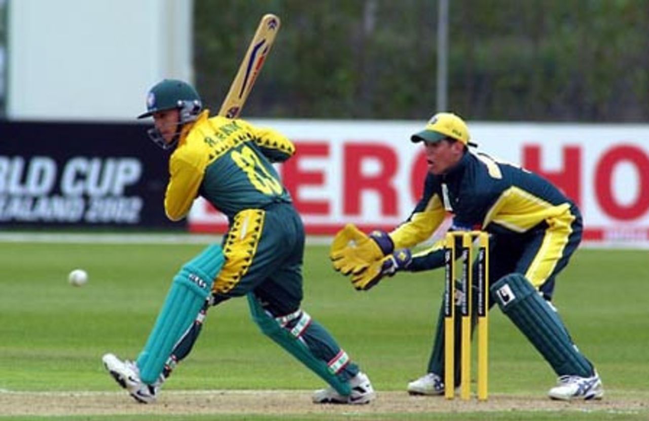 South Africa Under-19 batsman Riel de Kock shapes to play a delivery during his innings of 37. Australia Under-19 wicket-keeper Adam Crosthwaite looks on. ICC Under-19 World Cup Super League Group 2: Australia Under-19s v South Africa Under-19s at Bert Sutcliffe Oval, Lincoln, 28 January 2002.