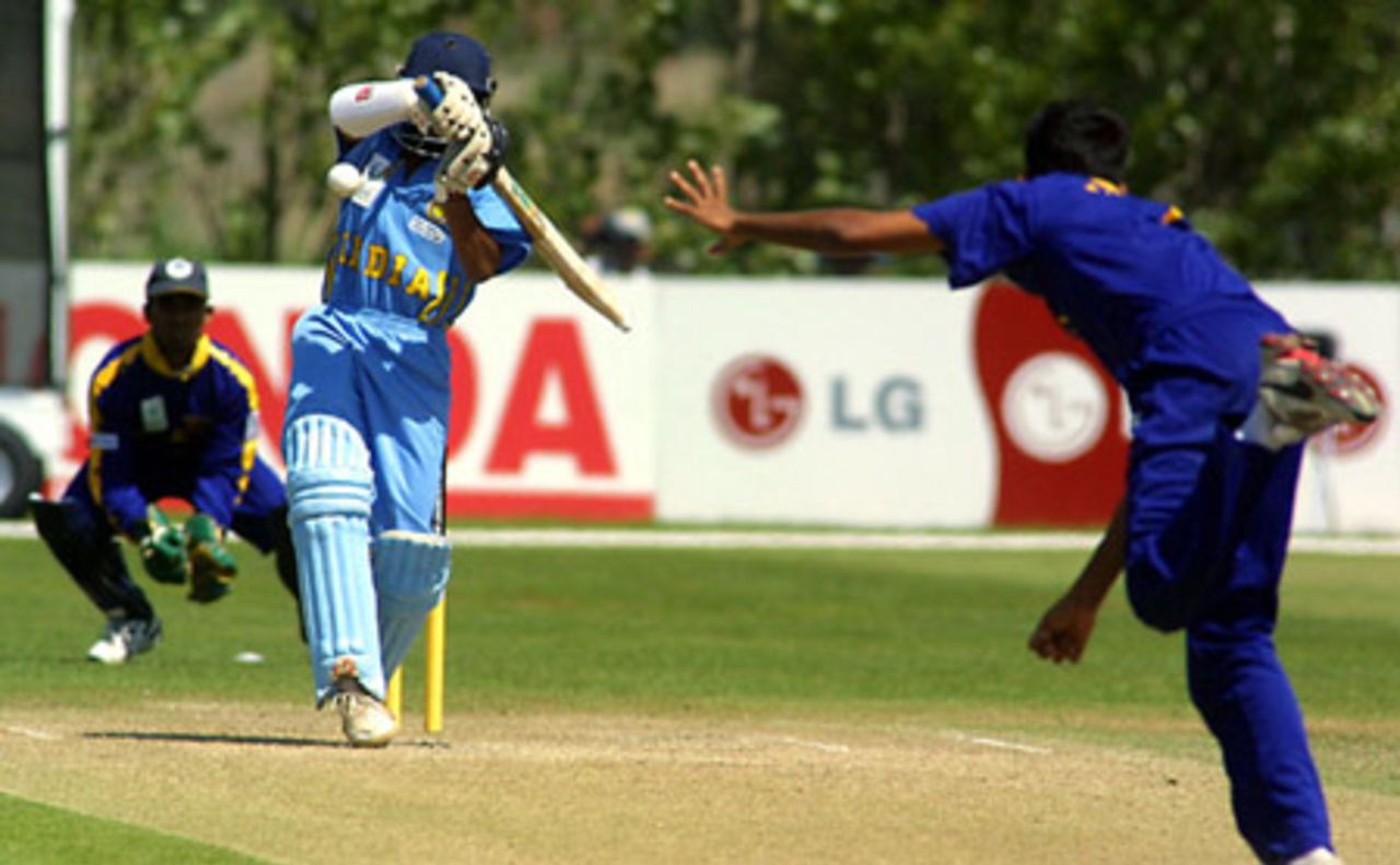 India Under-19 batsman Parthiv Patel attempts to shy away from a short ball from Sri Lanka Under-19 bowler Dhammika Niroshan during his innings of 24. Wicket-keeper Charith Sylvester looks on. ICC Under-19 World Cup Super League Group 1: India Under-19s v Sri Lanka Under-19s at Bert Sutcliffe Oval, Lincoln, 29 January 2002.