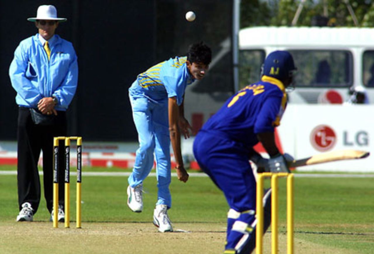 India Under-19 bowler Siddharth Trivedi delivers a ball to Sumalka Perera during his spell of 0-41 from nine overs. Umpire Dave Quested looks on. ICC Under-19 World Cup Super League Group 1: India Under-19s v Sri Lanka Under-19s at Bert Sutcliffe Oval, Lincoln, 29 January 2002.
