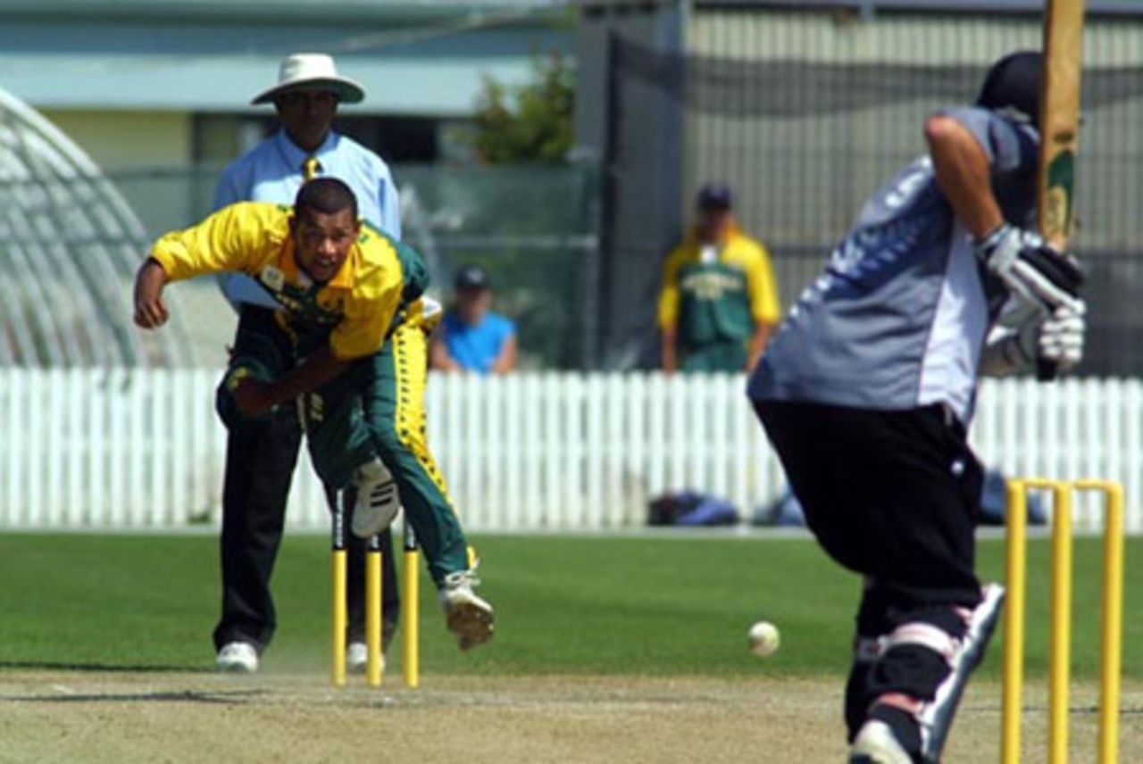 South Africa Under-19 bowler Brent Kopps delivers a ball to New Zealand Under-19 batsman Rob Nicol during his spell of 0-22 from four overs. Umpire Asoka de Silva from Sri Lanka looks on. ICC Under-19 World Cup Super League Group 2: New Zealand Under-19s v South Africa Under-19s at Lincoln Green, Lincoln, 30 January 2002.