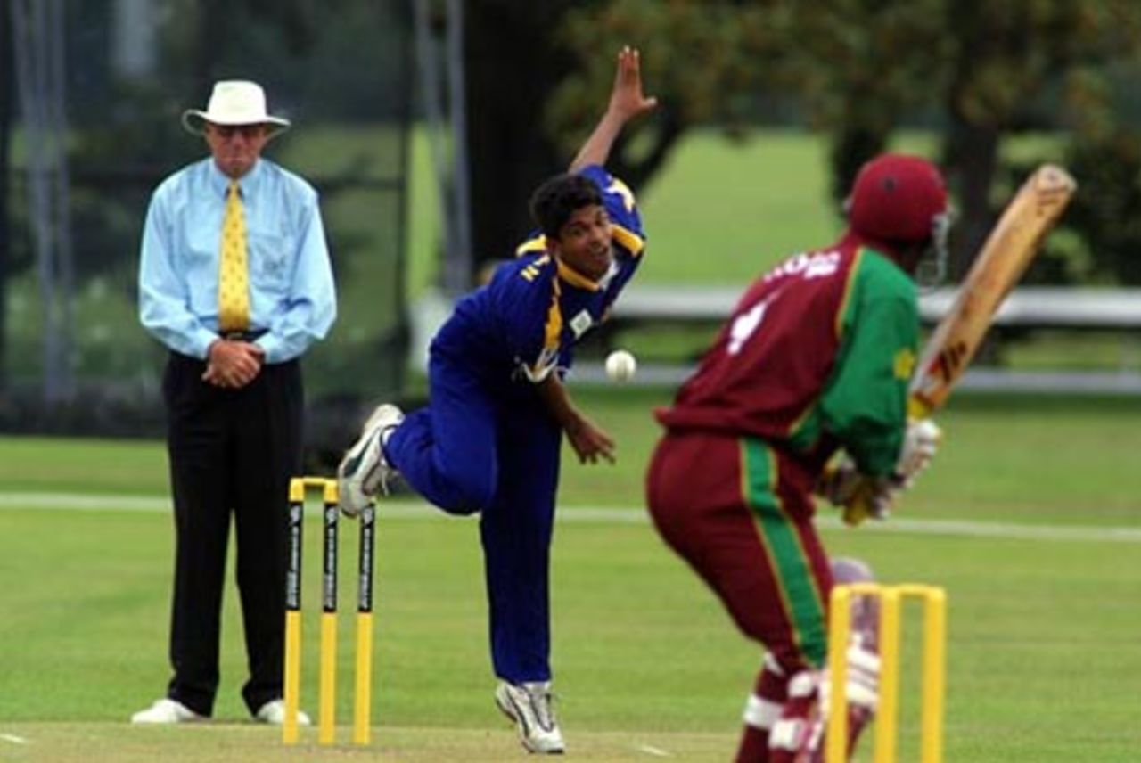Sri Lanka Under-19 bowler Dhammika Niroshan delivers a ball to West Indies Under-19 batsman Alcindo Holder during his spell of 3-36 from 10 overs. Umpire Tony Cooper from Fiji looks on. ICC Under-19 World Cup Super League Group 1: Sri Lanka Under-19s v West Indies Under-19s at Hagley Oval, Christchurch, 31 January 2002.