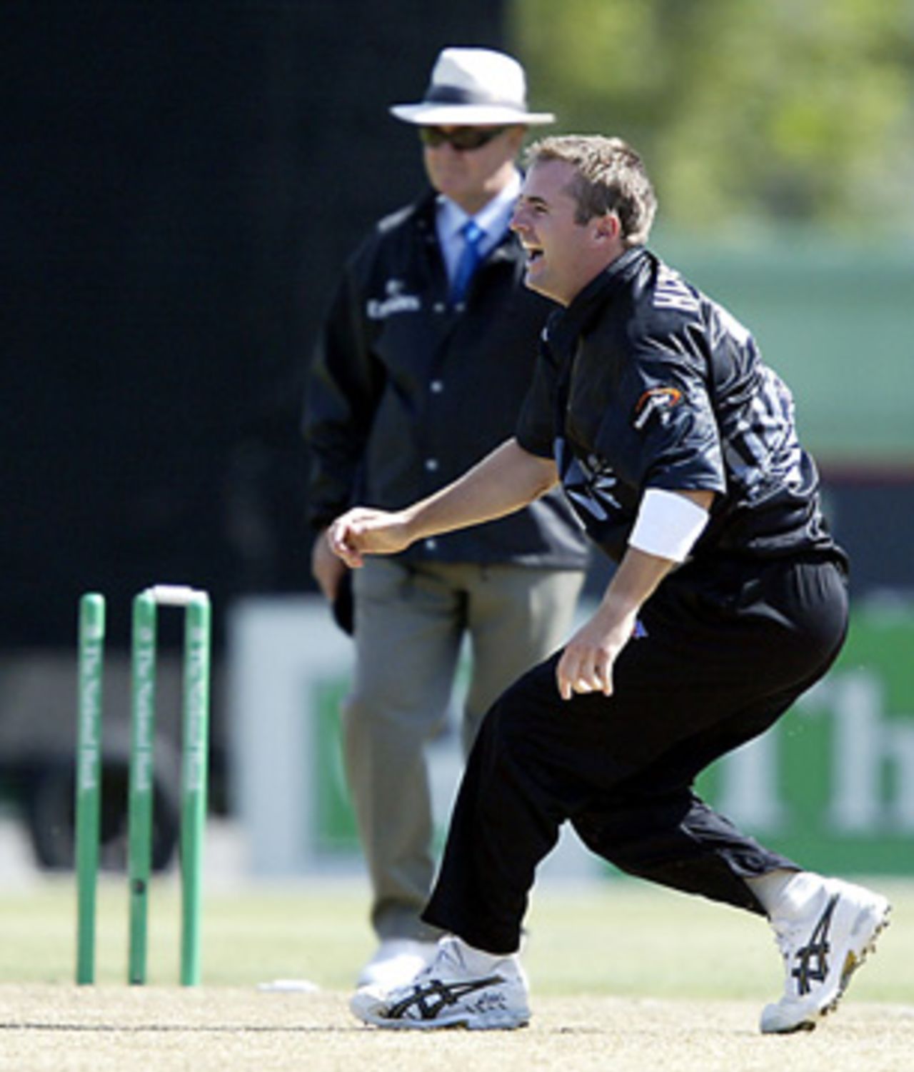 New Zealand bowler Paul Hitchcock celebrates the dismissal of Indian batsman Yuvraj Singh, run out by Hitchcock for 12. Umpire Doug Cowie looks on in the background. 3rd ODI: New Zealand v India at Jade Stadium, Christchurch, 1 January 2003.