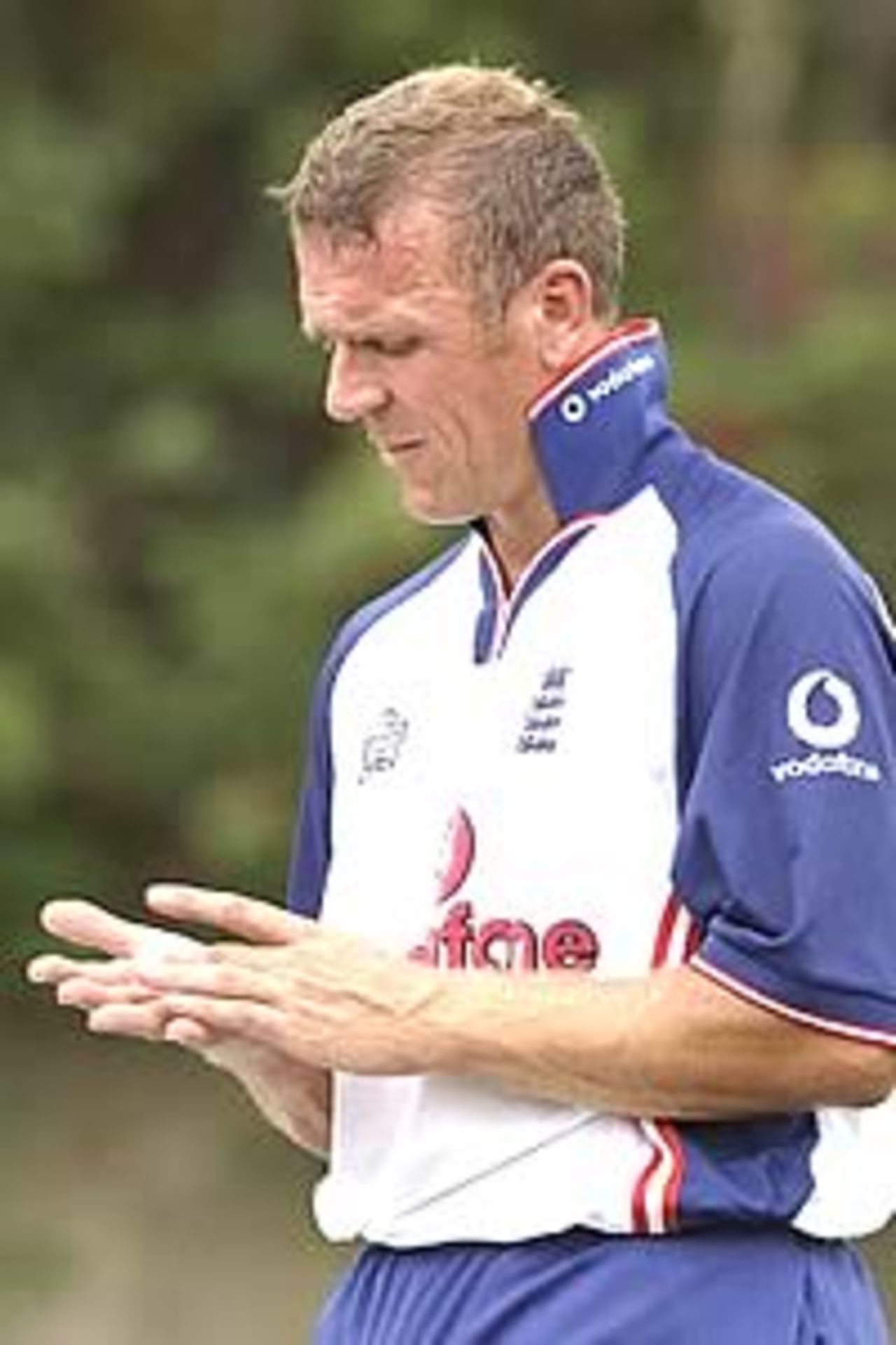 SYDNEY - JANUARY 1: Alec Stewart of England looks at his hand with team physiotherapist Kirk Russell during an England cricket team training session at the Sydney Cricket Ground in Sydney, Australia on January 1, 2003.
