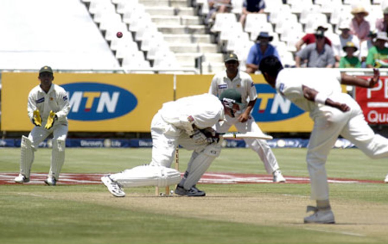 Graeme Smith ducking under a Waqar Younis delivery with Pakistans Kamran Akmal and Inzamam-ul-Haq looking on