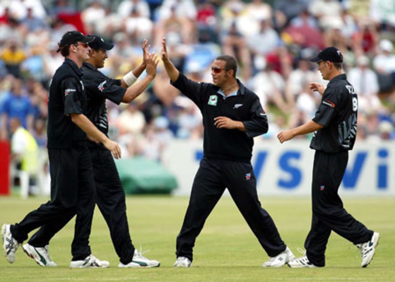 Members of the New Zealand team celebrate the dismissal of Indian batsman Yuvraj Singh, caught by Daryl Tuffey at deep midwicket off the bowling of Scott Styris for 25. From left: Kyle Mills, Tuffey, Andre Adams and Mathew Sinclair. 4th ODI: New Zealand v India at John Davies Oval, Queenstown, 4 January 2003.