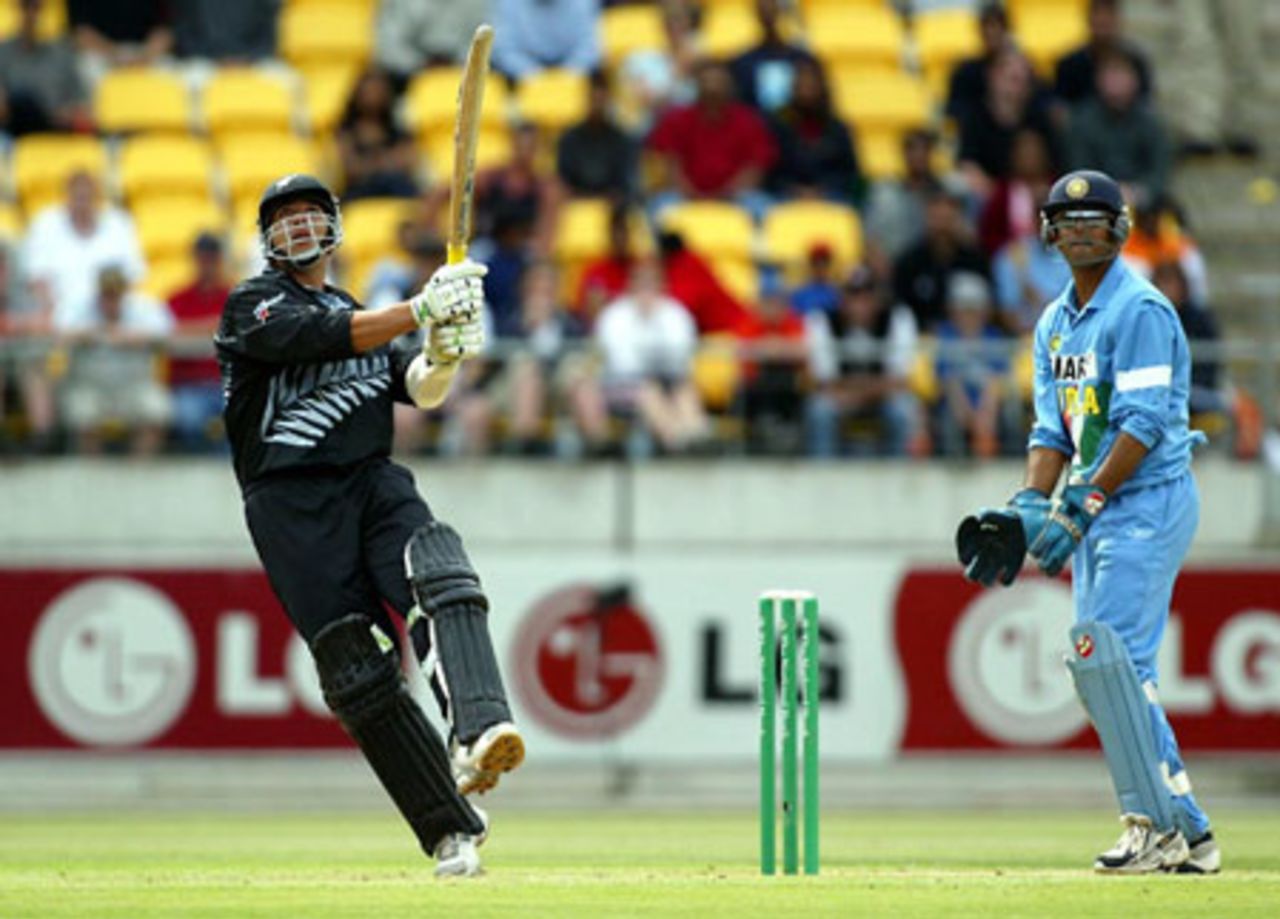 New Zealand batsman Andre Adams pulls a delivery over midwicket during his innings of 35 as Indian wicket-keeper Rahul Dravid look on. 5th ODI: New Zealand v India at Westpac Stadium, Wellington, 8 January 2003.