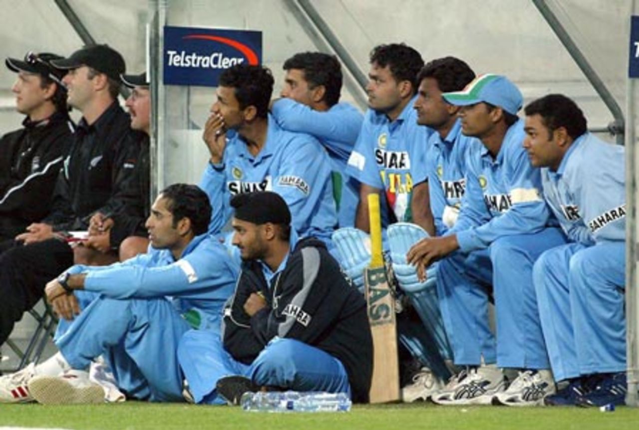 Members of both teams watch the action as the match draws to a tense conclusion. Seated (from left): New Zealand physiotherapist Dayle Shackel, training squad member Paul Hitchcock, player co-ordinator Ashley Ross; Indian player Sanjay Bangar, captain Sourav Ganguly, Dinesh Mongia, Javagal Srinath, Rakesh Patel, Virender Sehwag. On ground (from left): VVS Laxman and Harbhajan Singh. 5th ODI: New Zealand v India at Westpac Stadium, Wellington, 8 January 2003.