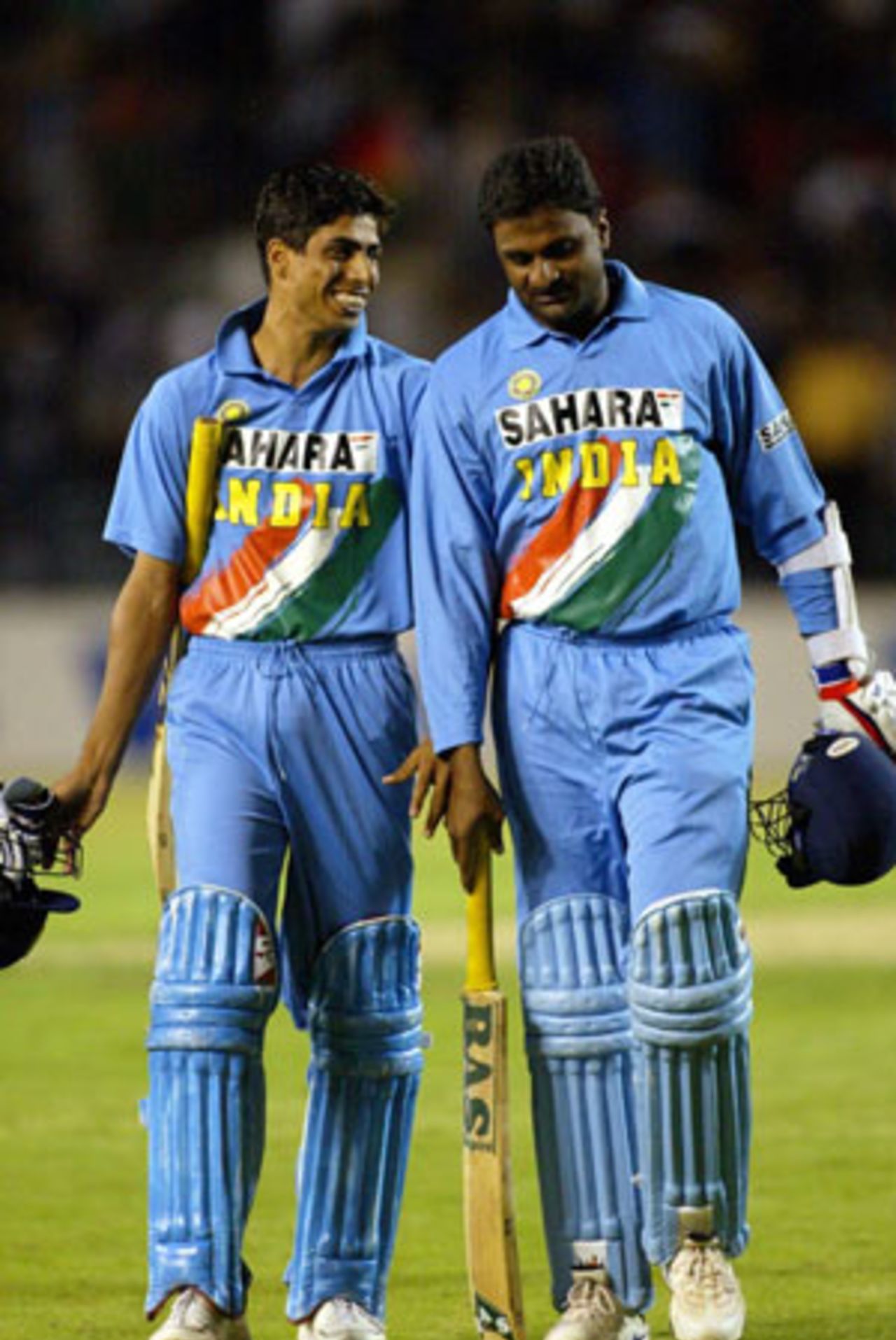 Indian batsmen Ashish Nehra (left) and Javagal Srinath celebrate as they leave the field at the end of the match. India beat New Zealand by one wicket. 6th ODI: New Zealand v India at Eden Park, Auckland, 11 January 2003.