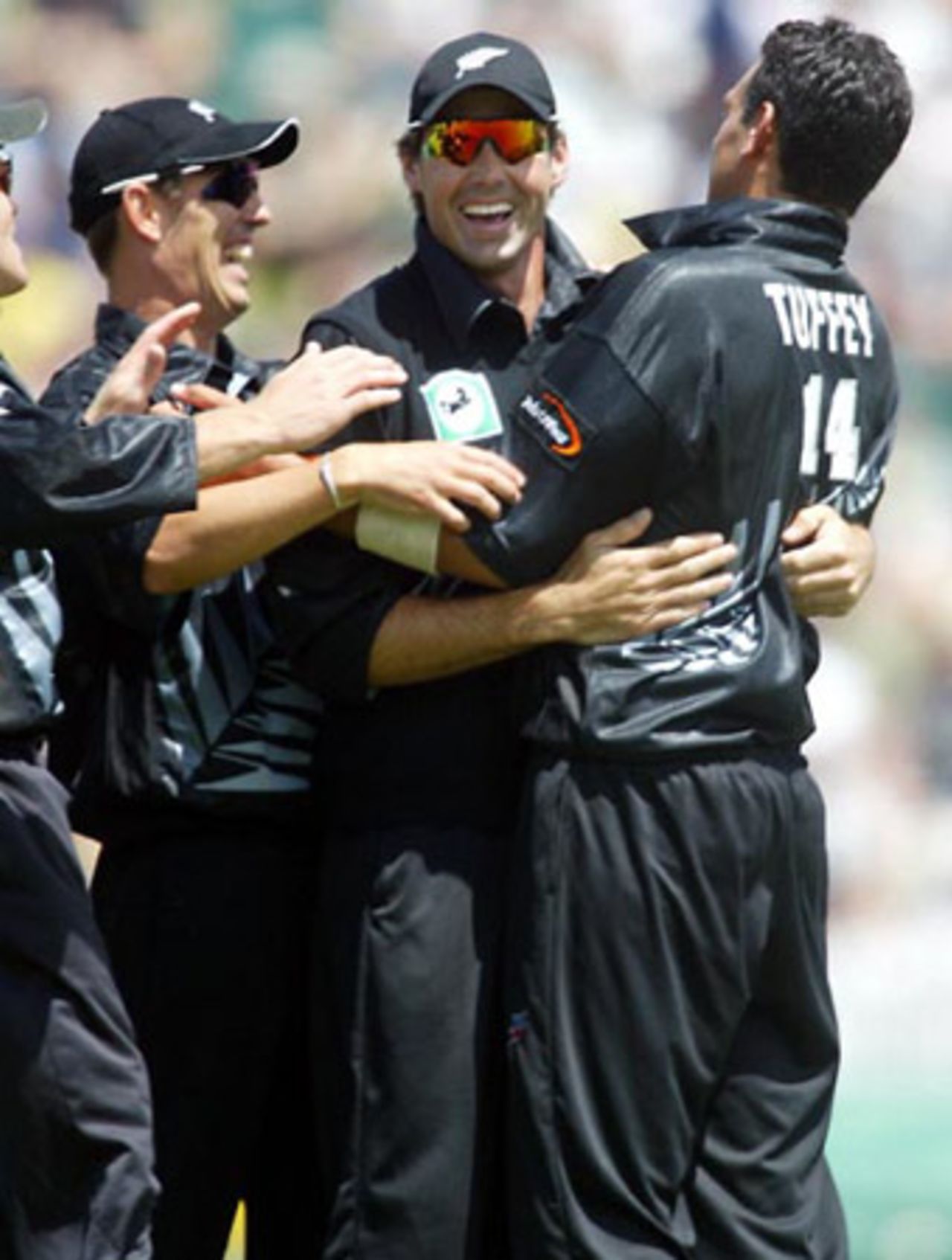New Zealand players Mathew Sinclair (left), Stephen Fleming and Daryl Tuffey celebrate the dismissal of Indian batsman Dinesh Mongia, caught by Fleming at first slip off the bowling of Tuffey for 0. 7th ODI: New Zealand v India at Westpac Park, Hamilton, 14 January 2003.