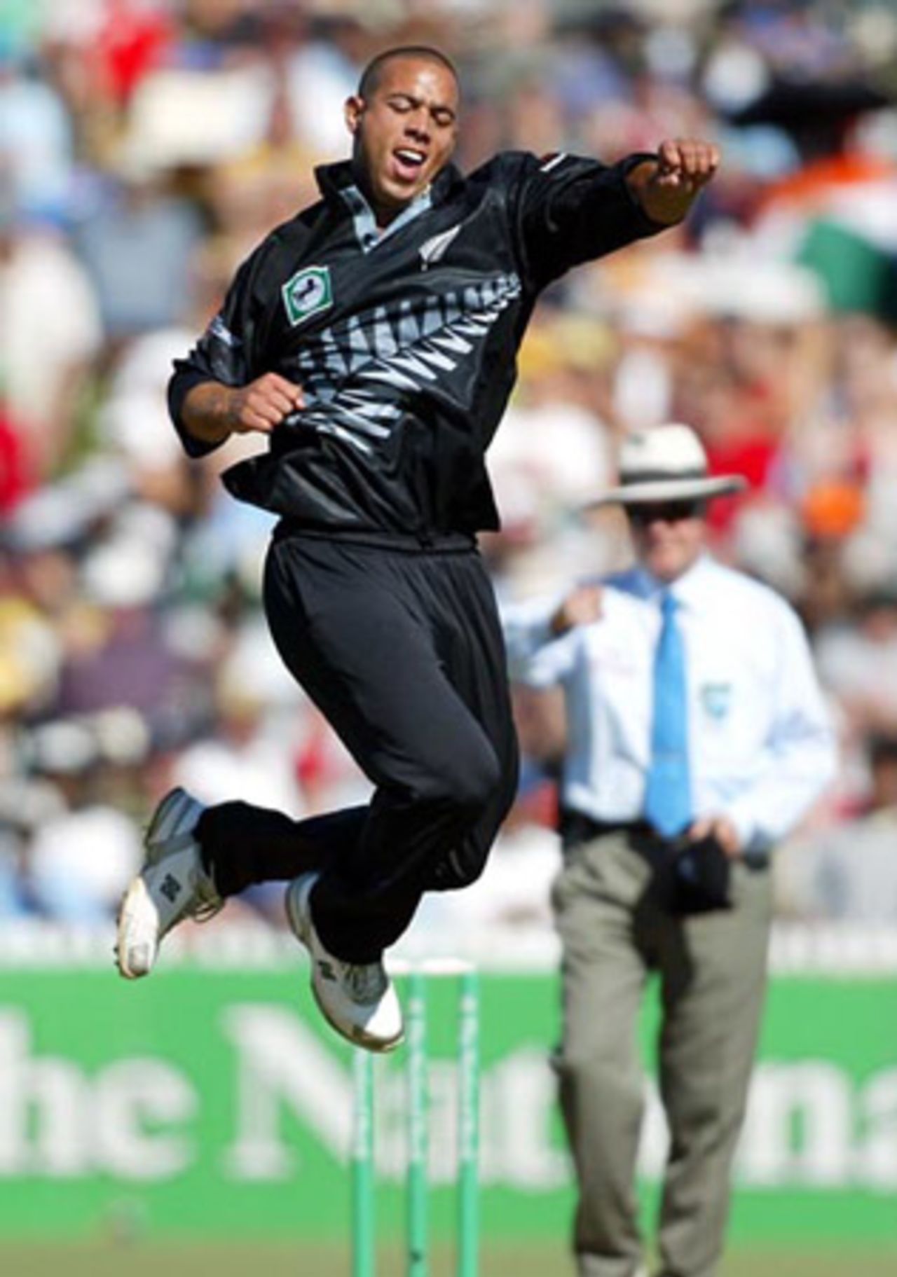 New Zealand bowler Andre Adams celebrates the dismissal of Indian batsman Javagal Srinath, lbw for 15 as umpire Doug Cowie raises his finger in the background. 7th ODI: New Zealand v India at Westpac Park, Hamilton, 14 January 2003.