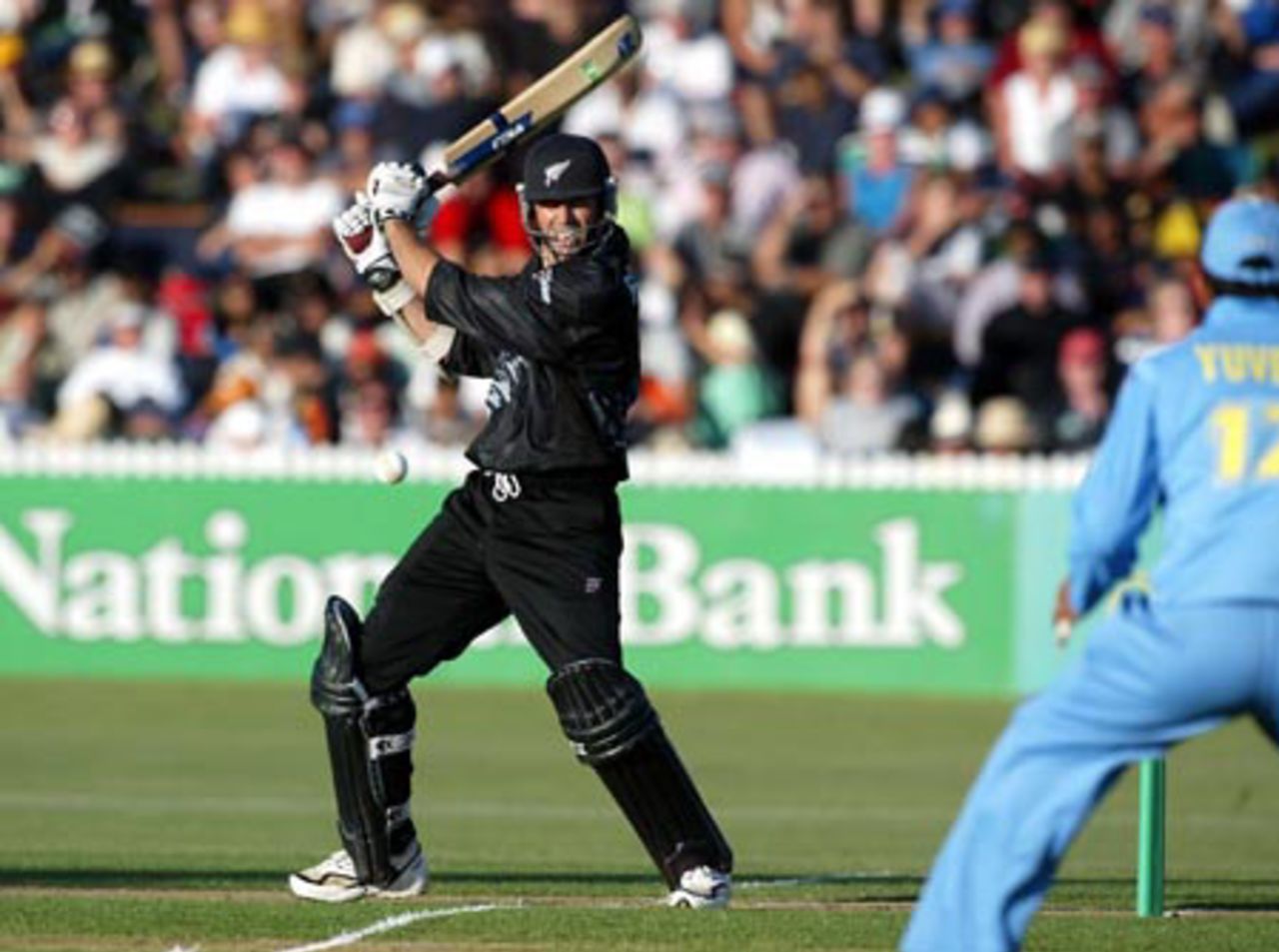 New Zealand batsman Stephen Fleming cuts a delivery through backward point during his innings of 60 not out. Indian fielder Yuvraj Singh looks on. 7th ODI: New Zealand v India at Westpac Park, Hamilton, 14 January 2003.