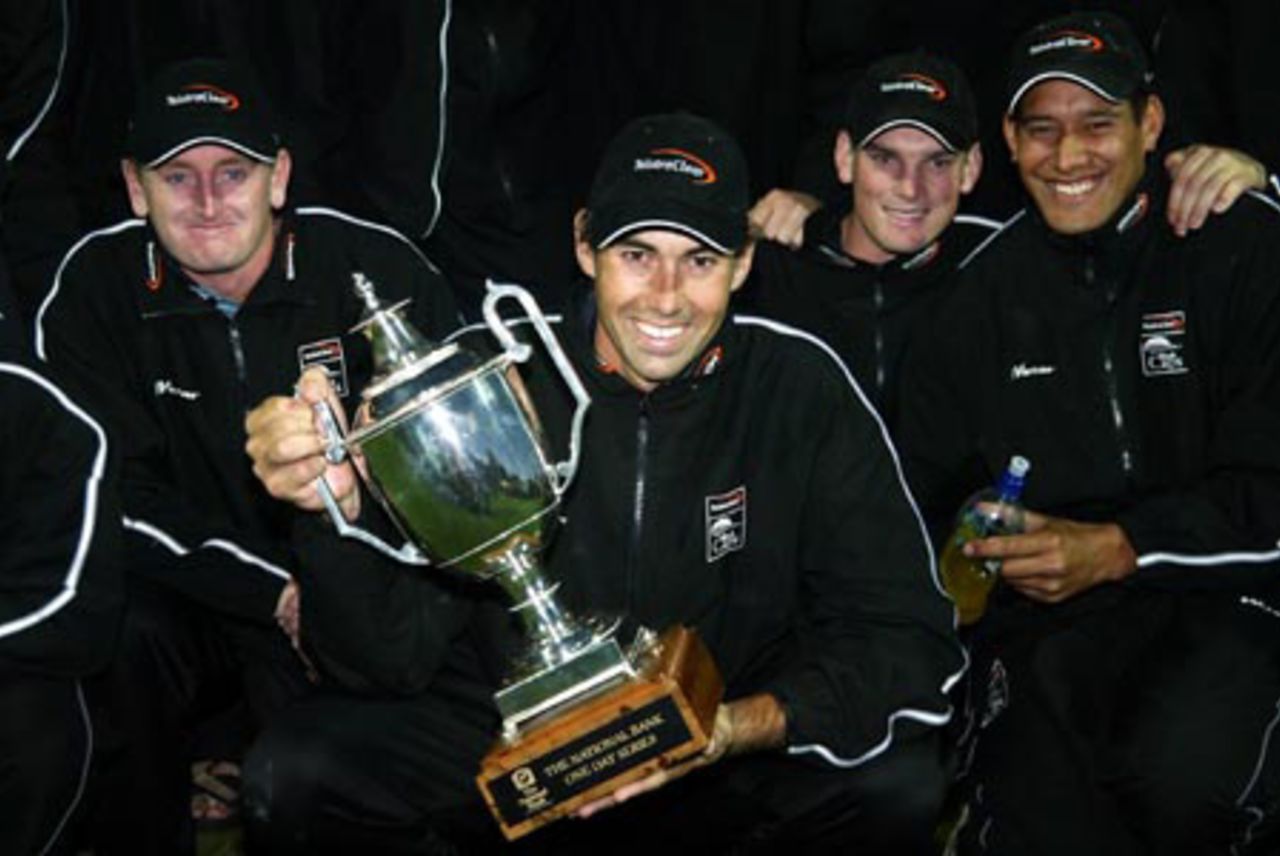 New Zealand captain Stephen Fleming (centre) holds the National Bank One-Day International Series trophy as team-mates Scott Styris (left), Kyle Mills and Daryl Tuffey look on. New Zealand won the seven-match series 5-2. 7th ODI: New Zealand v India at Westpac Park, Hamilton, 14 January 2003.