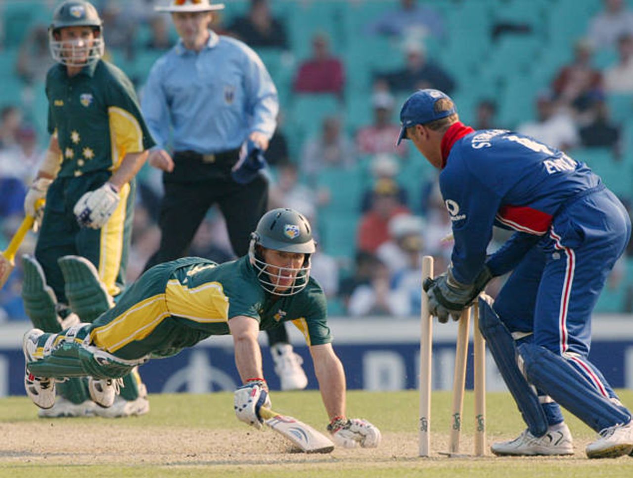 Australia A batsman Brad Hogg is run out by England's Alec Stewart as he attempts to dive back into the crease in Sydney, 8 Dec 2002