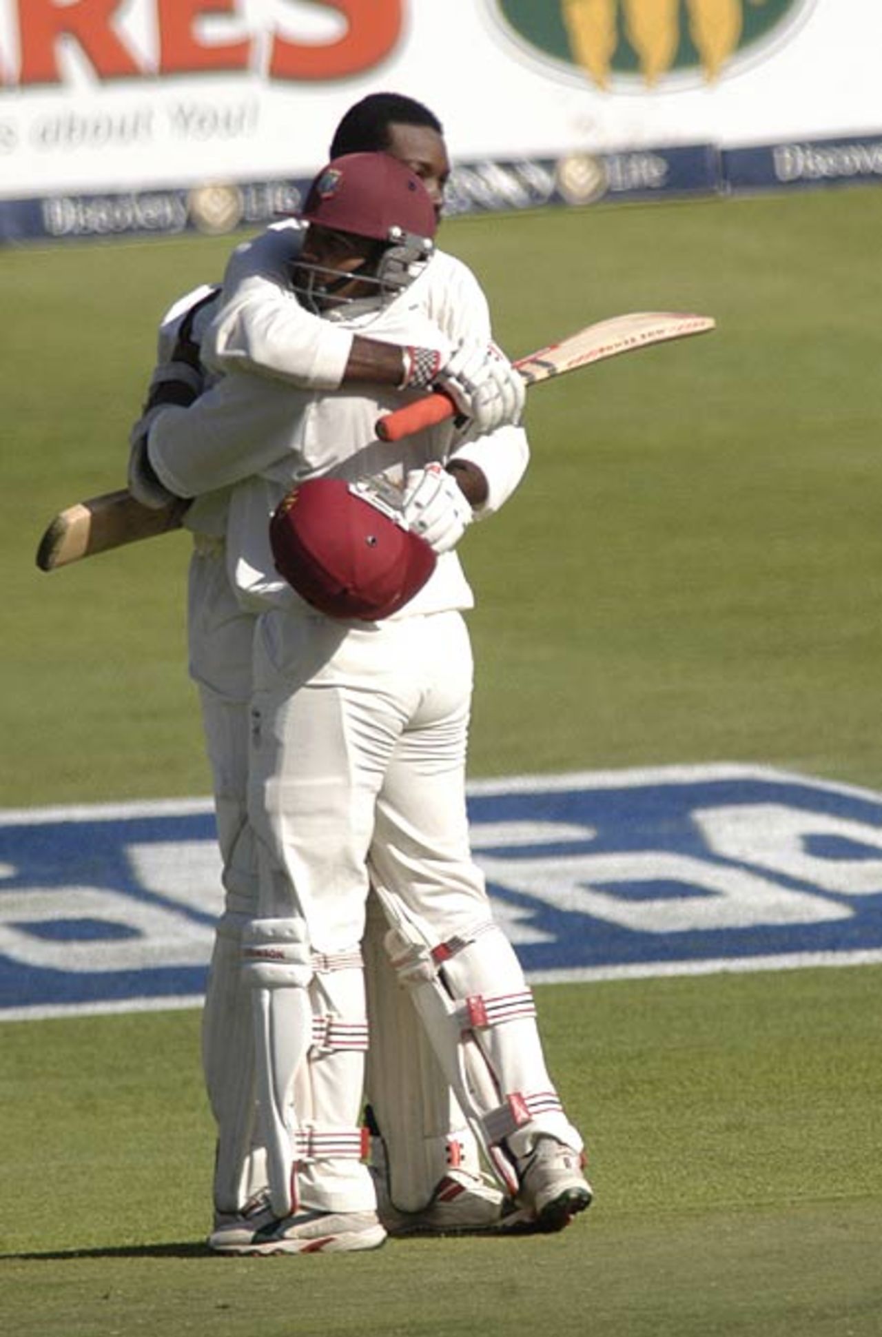 Chris Gayle celebrates his century with Darren Ganga during the third test against the South Africa at Newlands on Saturday