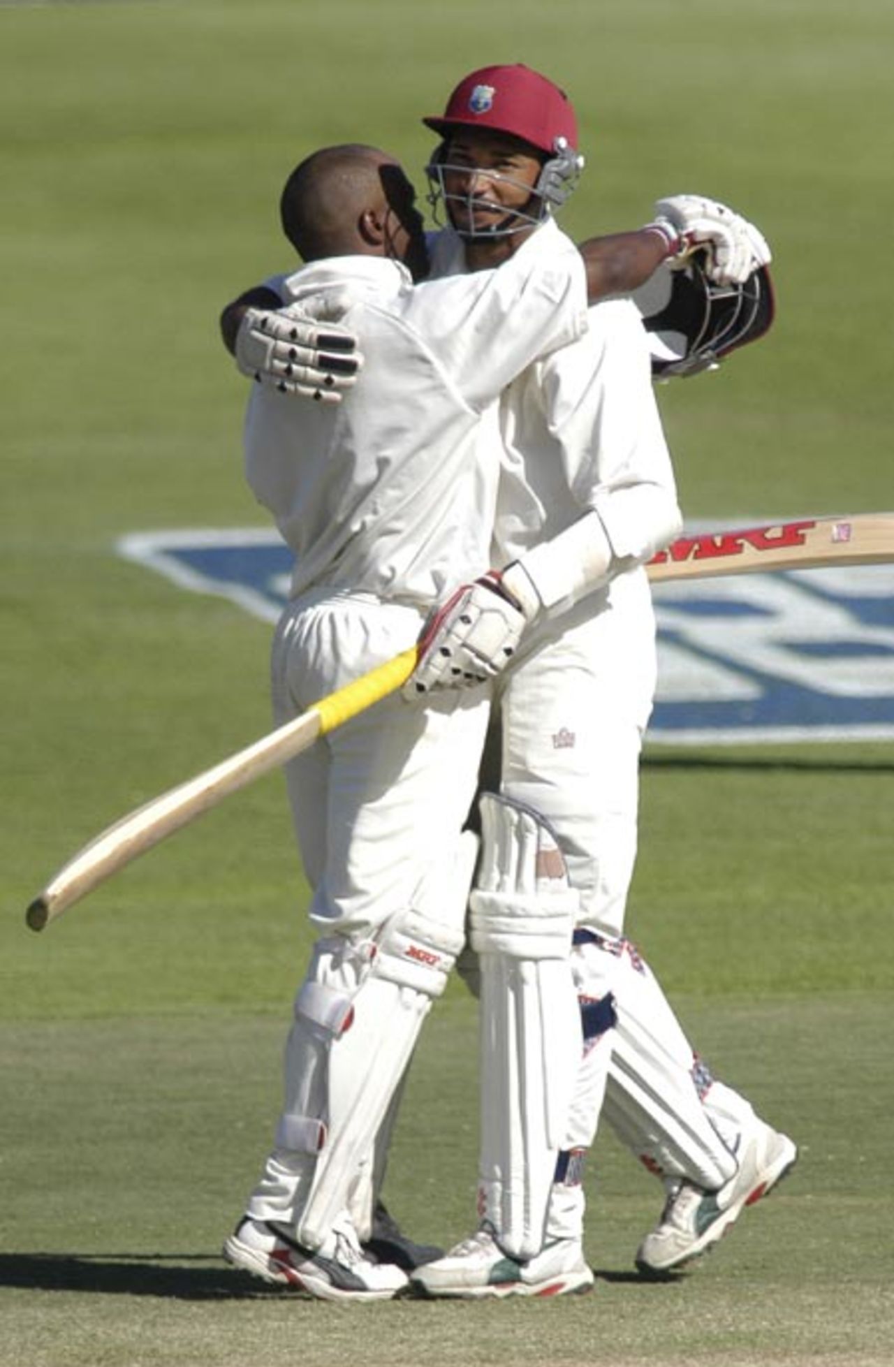 Brian Lara and Adam Stanford celebrate as Lara reaches his century at Newlands during the 3rd test match