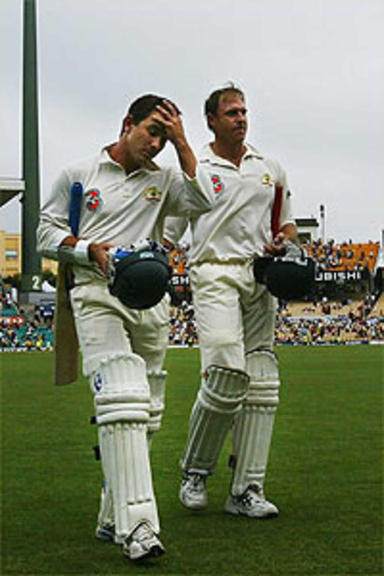 Justin Langer and Matthew Hayden of Australia leave the field together during day four of the 4th Test between Australia and India at the SCG on January 5, 2004 in Sydney, Australia