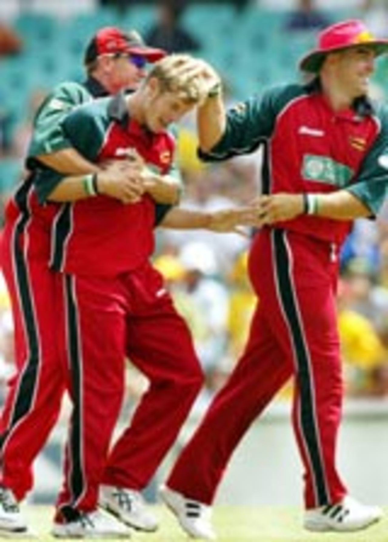 Andy Blignaut congratulated by Ray Price and Heath Streak, Australia v Zimbabwe, VB Series, Sydney, January 11, 2004