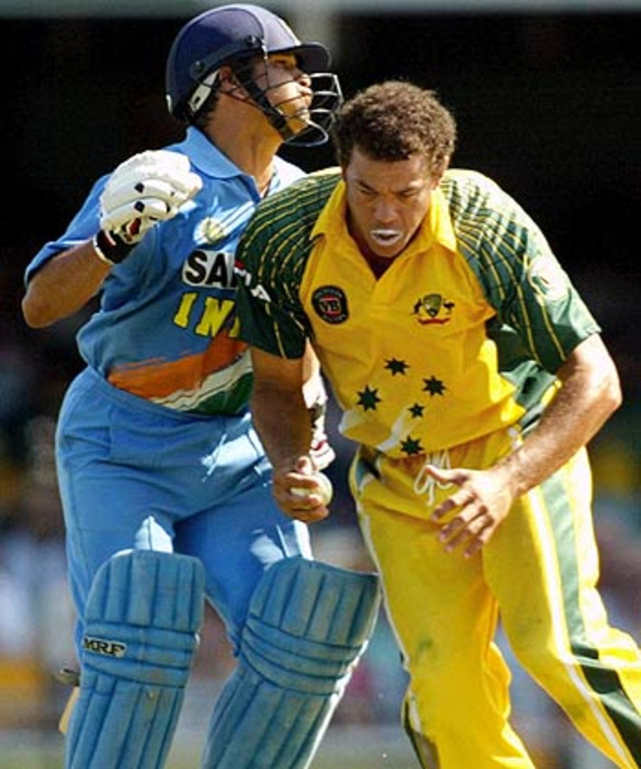 What about some Aussie Rules, mate? Andrew Symonds gets in Sachin Tendulkar's way, Australia v India, VB Series, Brisbane, 5th ODI, January 18, 2004