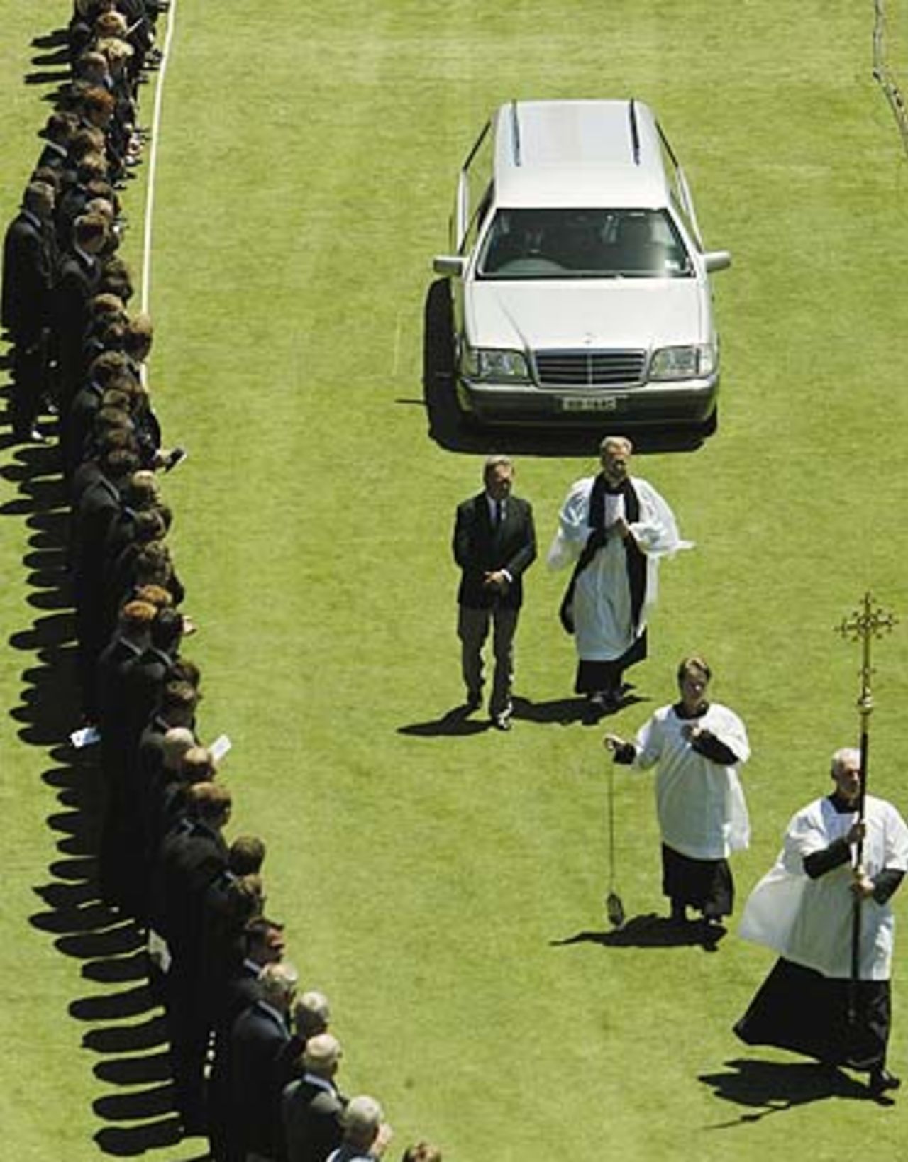 The hearse carries the coffin down a guard of honour formed by former and current cricketers, Adelaide, January 27, 2004
